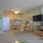 Great view of the kitchen and HD TV from the couch and a ceiling fan in the kitchen